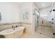 Bright bathroom boasting a modern tub, a glass-enclosed shower and elegant tile at 134 Chesapeake Ave, Tampa, FL 33606