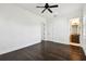 Bright bedroom with hardwood floors, white walls, ceiling fan and a bathroom at 134 Chesapeake Ave, Tampa, FL 33606