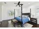 Bedroom featuring a dark wood four-poster bed, ceiling fan, and natural light from the window at 134 Chesapeake Ave, Tampa, FL 33606