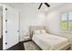 Bright bedroom showcasing a tufted bed, a light-colored rug, and shuttered window with green outside at 134 Chesapeake Ave, Tampa, FL 33606