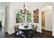 Cozy dining area with built-in seating, a chandelier, and a view of lush greenery at 134 Chesapeake Ave, Tampa, FL 33606