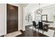 Bright dining room boasts a designer chandelier, large windows, and dark wood floors at 134 Chesapeake Ave, Tampa, FL 33606