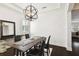 Stylish dining room offering tray ceilings, a modern chandelier, and natural light at 134 Chesapeake Ave, Tampa, FL 33606