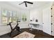 Bright exercise room with Peloton bike, multiple windows, wood floors, and a ceiling fan at 134 Chesapeake Ave, Tampa, FL 33606