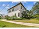 Two-story home with a neutral color scheme, a tile roof, and manicured landscaping at 134 Chesapeake Ave, Tampa, FL 33606