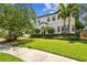 Charming two-story home with lush landscaping, manicured lawn, and a well-maintained sidewalk at 134 Chesapeake Ave, Tampa, FL 33606