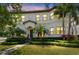 Stately two-story home featuring lush landscaping, manicured lawn, and a tile roof at 134 Chesapeake Ave, Tampa, FL 33606