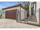 Attached garage with wooden doors, alongside a gated entrance to the property at 134 Chesapeake Ave, Tampa, FL 33606
