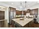 Stylish kitchen featuring a wine cooler, stainless steel fridge, and hanging pendant lights at 134 Chesapeake Ave, Tampa, FL 33606