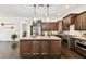 Open kitchen design with central island, wooden cabinets, and modern stainless steel appliances at 134 Chesapeake Ave, Tampa, FL 33606