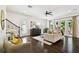 Bright living room with dark hardwood floors, staircase, and large windows at 134 Chesapeake Ave, Tampa, FL 33606