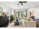 Bright living room with dark hardwood floors, a ceiling fan, and french doors at 134 Chesapeake Ave, Tampa, FL 33606