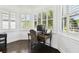 Office space features a desk, chair, and natural light from the three windows at 134 Chesapeake Ave, Tampa, FL 33606