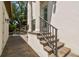 Side entrance to the home featuring stone steps and a wrought iron railing at 134 Chesapeake Ave, Tampa, FL 33606