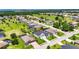 Aerial view of a landscaped home with a manicured lawn and neighborhood at 13539 Carryback Dr, Dade City, FL 33525