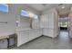 Bright bathroom featuring white cabinets, a large mirror, and an open view into the hall at 13539 Carryback Dr, Dade City, FL 33525