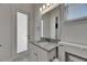 Bathroom with door to outdoors and quartz countertops at 13539 Carryback Dr, Dade City, FL 33525