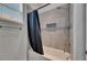 Well-lit bathroom features a tiled shower and bathtub combination with stylish fixtures at 13539 Carryback Dr, Dade City, FL 33525