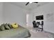 Comfortable bedroom features a plush bed and dedicated workspace with desk and wall-mounted television at 13539 Carryback Dr, Dade City, FL 33525