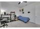 Bedroom featuring a comfortable sleeping area, ceiling fan and workspace with storage shelves at 13539 Carryback Dr, Dade City, FL 33525