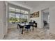 Sunny dining area with backyard views, a modern light fixture, and convenient access to the bedroom at 13539 Carryback Dr, Dade City, FL 33525