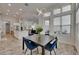 Open concept dining room with modern light fixture, overlooking the kitchen and living space at 13539 Carryback Dr, Dade City, FL 33525