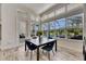 Bright dining room with tile floors, modern lighting, and large windows overlooking the pool at 13539 Carryback Dr, Dade City, FL 33525