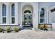 Grand entrance with double doors, stone pathway, and elegant architectural details at 13539 Carryback Dr, Dade City, FL 33525