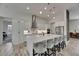 Bright kitchen featuring stainless steel appliances, an island with seating, and sleek white cabinetry at 13539 Carryback Dr, Dade City, FL 33525