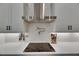 Gourmet kitchen featuring modern appliances, pot filler, and subway tile backsplash at 13539 Carryback Dr, Dade City, FL 33525