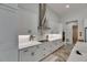 Modern kitchen featuring white cabinets, stainless steel appliances, and stylish wood-look tile flooring at 13539 Carryback Dr, Dade City, FL 33525