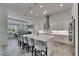Open kitchen and dining area with stainless appliances, an island, and bright natural light at 13539 Carryback Dr, Dade City, FL 33525