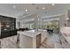 Open concept kitchen with island seating overlooking the Gathering room and outdoor area at 13539 Carryback Dr, Dade City, FL 33525