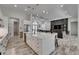 Bright, open kitchen with a large island, stainless appliances, and a view of the adjacent living area at 13539 Carryback Dr, Dade City, FL 33525