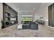 Spacious living room with a stylish entertainment center, modern furnishings, and ample natural light at 13539 Carryback Dr, Dade City, FL 33525