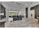 Open-concept living room with modern decor, recessed lighting, and large windows at 13539 Carryback Dr, Dade City, FL 33525