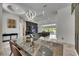 Bright dining area leading into living room; open floorplan with modern lighting and decor at 13539 Carryback Dr, Dade City, FL 33525