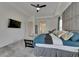 Main bedroom showcasing a bed with headboard, side tables, and a fan at 13539 Carryback Dr, Dade City, FL 33525