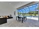 Covered patio with stylish outdoor furniture and a stunning view of the pool and backyard at 13539 Carryback Dr, Dade City, FL 33525