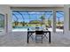 Enjoy outdoor dining on this covered patio overlooking the sparkling pool and manicured backyard at 13539 Carryback Dr, Dade City, FL 33525