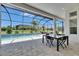 Relax on the spacious covered patio with views of the refreshing pool and lush landscaping at 13539 Carryback Dr, Dade City, FL 33525