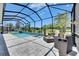 Relaxing screened-in lanai featuring a pool and comfortable lounge seating at 13539 Carryback Dr, Dade City, FL 33525