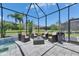 Screened-in patio with dark wicker furniture surrounding the pool area at 13539 Carryback Dr, Dade City, FL 33525