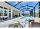 Stunning pool area with covered patio and outdoor seating at 13539 Carryback Dr, Dade City, FL 33525