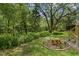 A lush green backyard borders a verdant landscaped perimeter abundant with native vegetation and a screened porch at 15314 Sherwood Forest Dr, Tampa, FL 33647