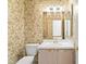 Cozy powder room featuring floral wallpaper and traditional fixtures at 15314 Sherwood Forest Dr, Tampa, FL 33647