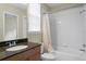 Well-lit bathroom featuring a shower-tub combo and granite countertop at 15314 Sherwood Forest Dr, Tampa, FL 33647