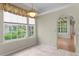 Bright breakfast nook featuring tile flooring, a large window, and a hanging light fixture at 15314 Sherwood Forest Dr, Tampa, FL 33647