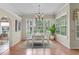 Dining room with hardwood floors, ample natural light, and elegant decor at 15314 Sherwood Forest Dr, Tampa, FL 33647