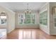 Dining room featuring hardwood floors, modern lighting, and large windows at 15314 Sherwood Forest Dr, Tampa, FL 33647